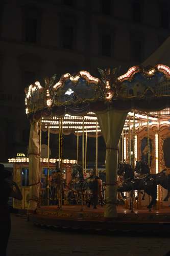 human lighted carousel at nigh time carousel